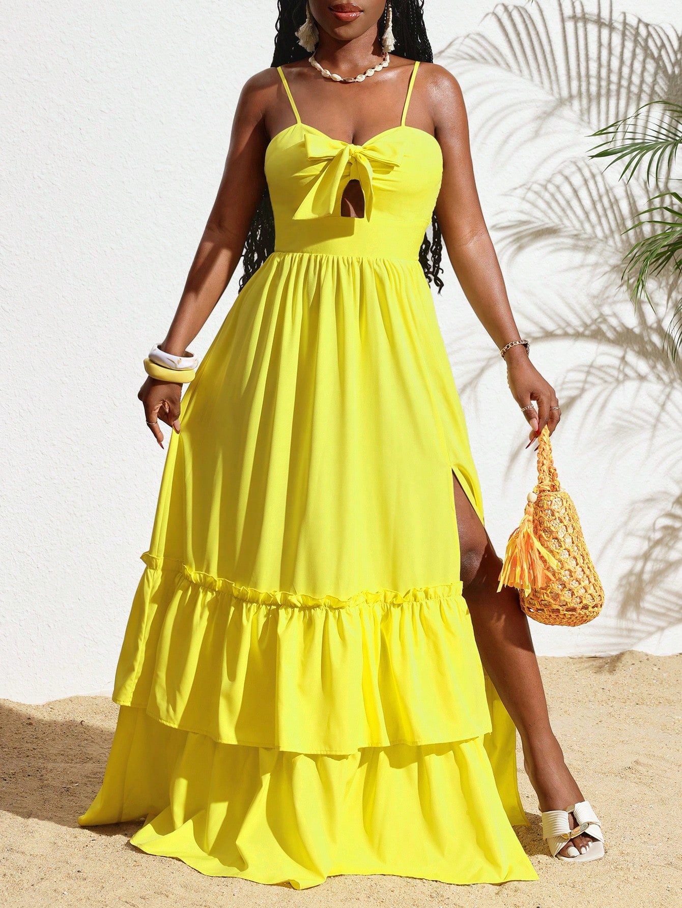 Get ready to turn heads this summer with our Women's Yellow Spaghetti Strap Dress! Featuring a playful ruffle hem and a stylish slit, this dress is perfect for any occasion. Made with lightweight fabric, stay cool and fashionable all season long.