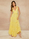 Step into summer fun with this playful maxi dress featuring tiered frills and charming tie straps. Easy-to-wear buttons add a touch of whimsy while offering a comfortable fit. Perfect for sunny days and breezy evenings, this dress brings effortless style with a flirtatious flair.
