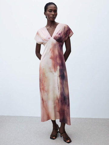This playful tie-dye asymmetric dress brings effortless style to your everyday wardrobe. Its flowing A-line cut flatters every figure, while the unique asymmetric hem adds a fun, unexpected twist. Perfect for any season, dress it up or down to match your mood and make every day a little more colorful and fabulous.
