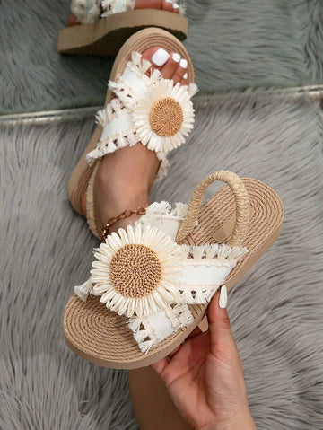 Handheld top view of cream floral slingback wedge sandals with camel soles