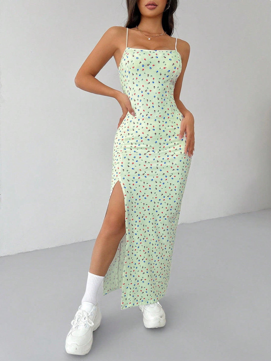 Effortlessly stylish and perfect for summer, our Women's White Ditsy Floral High Split Long Cami Dress is a must-have! Featuring a playful ditsy floral print and a high split for added flair, this dress will keep you cool and chic all season long.
