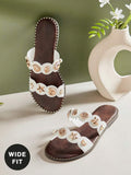 Effortless style meets everyday comfort in these women's wide-fit sandals. The minimalist design features sleek metal accents that elevate any casual look, while the slip-on construction makes them perfect for quick errands or leisurely days. Flat soles provide reliable support, and the generous wide fit ensures all-day wearability without compromise. A versatile essential for warm-weather wardrobes.