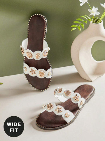 Effortless style meets everyday comfort in these women's wide-fit sandals. The minimalist design features sleek metal accents that elevate any casual look, while the slip-on construction makes them perfect for quick errands or leisurely days. Flat soles provide reliable support, and the generous wide fit ensures all-day wearability without compromise. A versatile essential for warm-weather wardrobes.