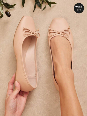 Effortless elegance for every step. These women's wide-fit ballet flats combine timeless design with all-day comfort. The slip-on silhouette means no fussing with laces—just slide in and go. Crafted with a spacious fit that accommodates wider feet without sacrificing style, they're perfect for the office, casual outings, or anywhere you need polished simplicity. Soft, flexible soles adapt to your natural stride, while the classic profile pairs seamlessly with dresses, jeans, or trousers. 