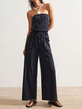 Front view of washed charcoal strapless wide-leg jumpsuit with drawstring waist and patch pockets