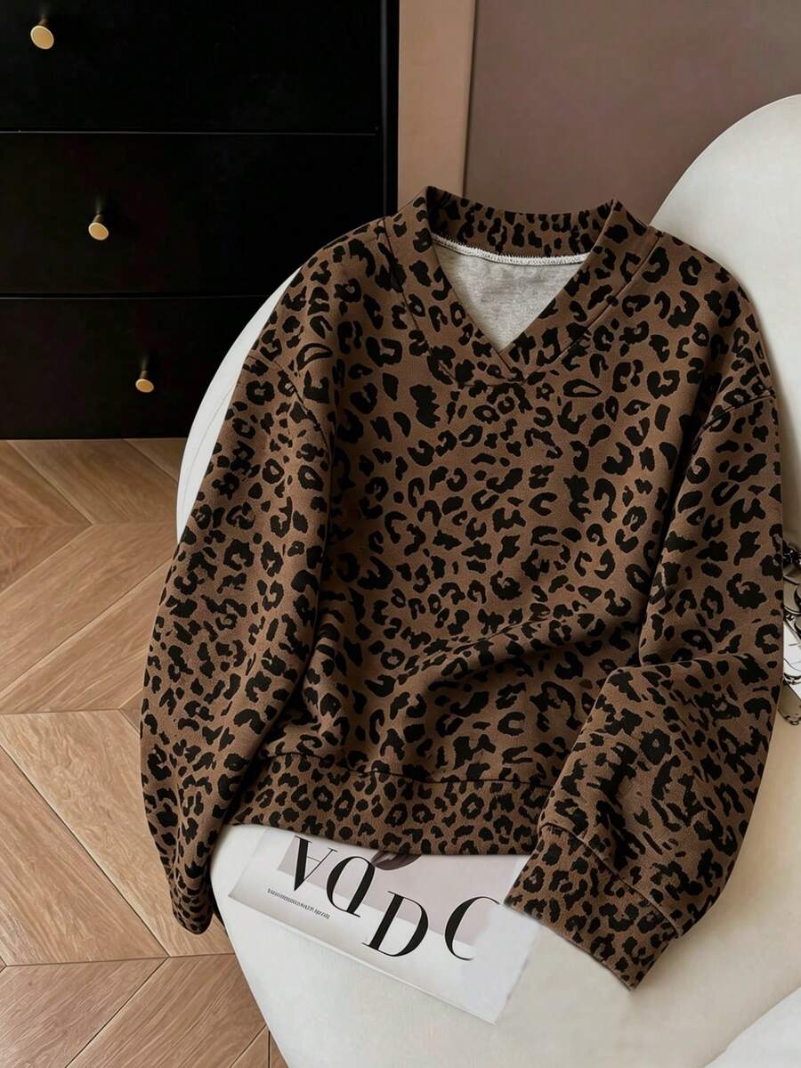 Chocolate brown leopard-print oversized V-neck sweatshirt shown in a styled front flat-lay