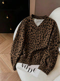 Chocolate brown leopard-print oversized V-neck sweatshirt shown in a styled front flat-lay