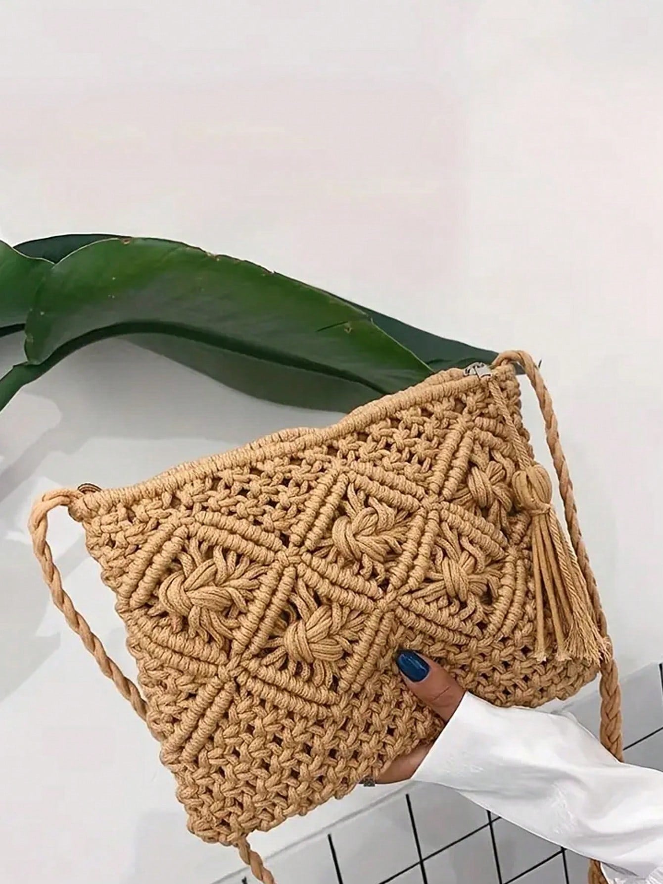 This stylish woven crossbody bag is perfect for your next vacation or casual outing. With its versatile design, it can easily transition from day to night. Its spacious interior and durable construction make it a must-have for your travels. Say goodbye to bulky bags and hello to effortless style.