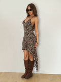 Front three-quarter indoor view of black floral high-low halter dress with flowing long back