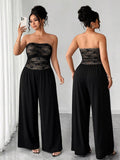Front and back views of black jumpsuit showing strapless lace bodice and flowing trousers