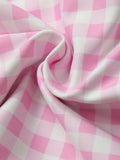 Pink and white plaid activewear tank with coordinating high-waisted shorts