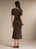 Back view brown polka-dot midi dress with waist tie and lace cuffs