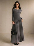 Close front detail of the black and cream striped maxi dress showing round neckline, buttons, and fitted waist