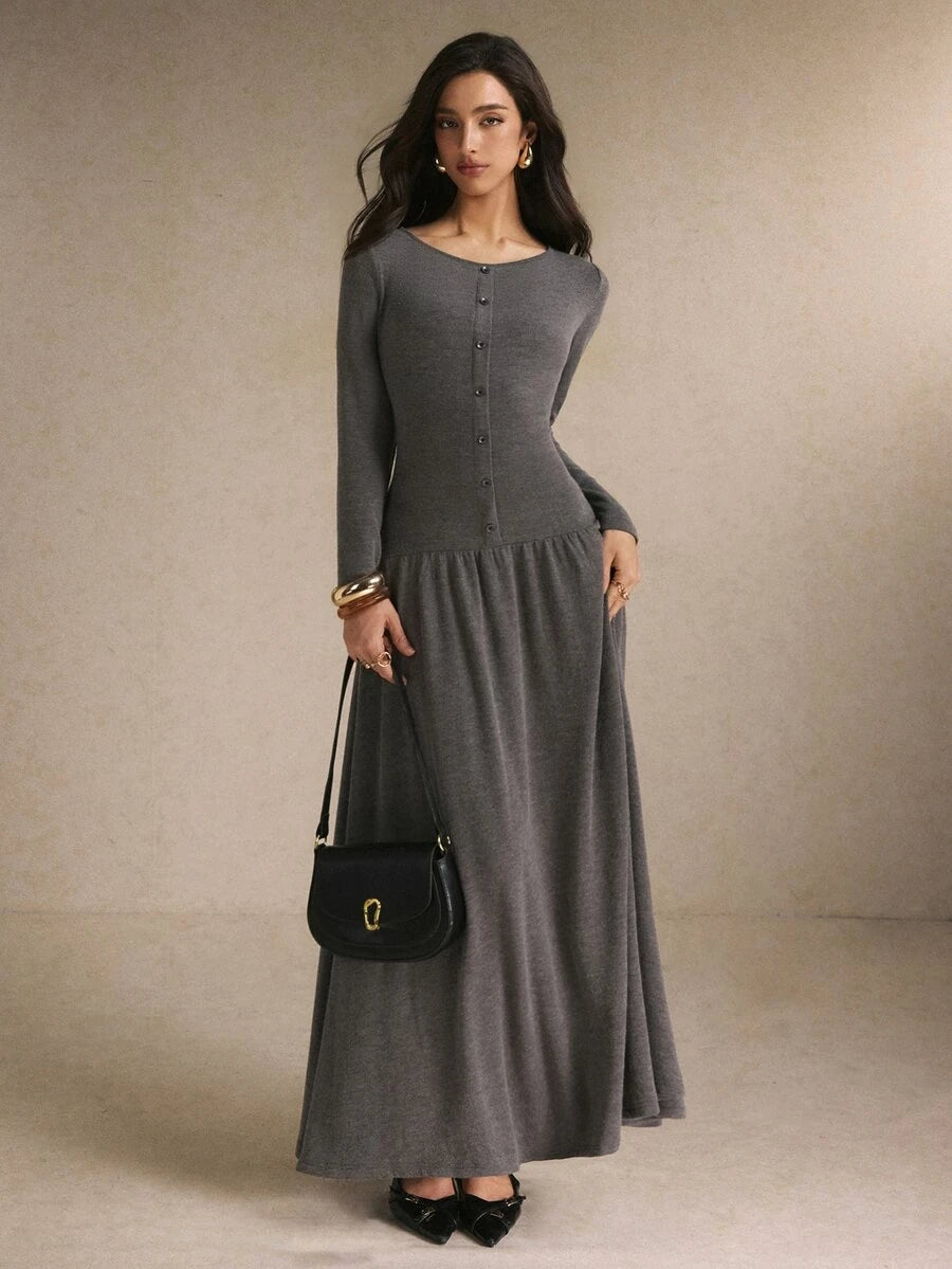 Close front detail of the black and cream striped maxi dress showing round neckline, buttons, and fitted waist