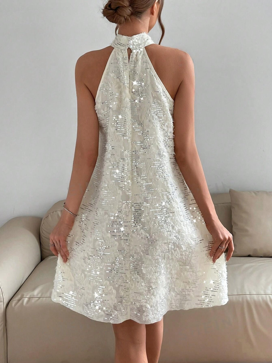 Sparkle & Shine with our Solid Sequin Halter Dress! Designed for dazzling evenings, this dress features a halter neckline and all-over sequin detailing. Perfect for any special occasion, it will make you shine bright and stand out from the crowd. Elevate your style and make a statement with this stunning dress.