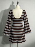 Back view of brown striped mini dress showing deep scoop back and tie closure