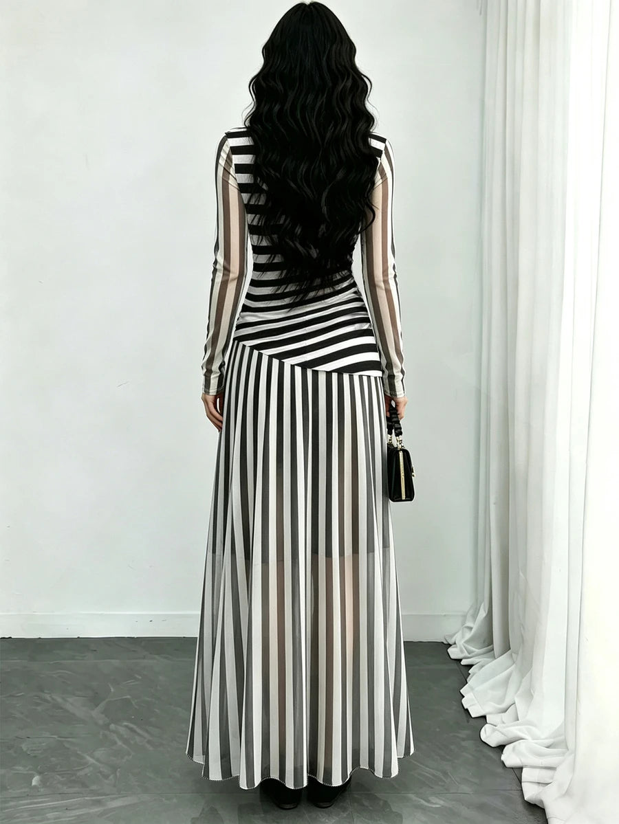 Full front view of long striped maxi dress with sheer-look sleeves and flared floor-length skirt