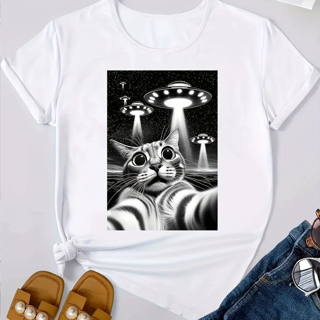This Cats and UFO Printed T-Shirt is the perfect addition to any women's clothing collection. With a casual short sleeve design and comfortable crew neck, this t-shirt is both stylish and comfortable. The unique print featuring cats and UFOs adds a fun and playful touch to any outfit. Crafted with high-quality materials, this t-shirt is sure to become a wardrobe staple.
