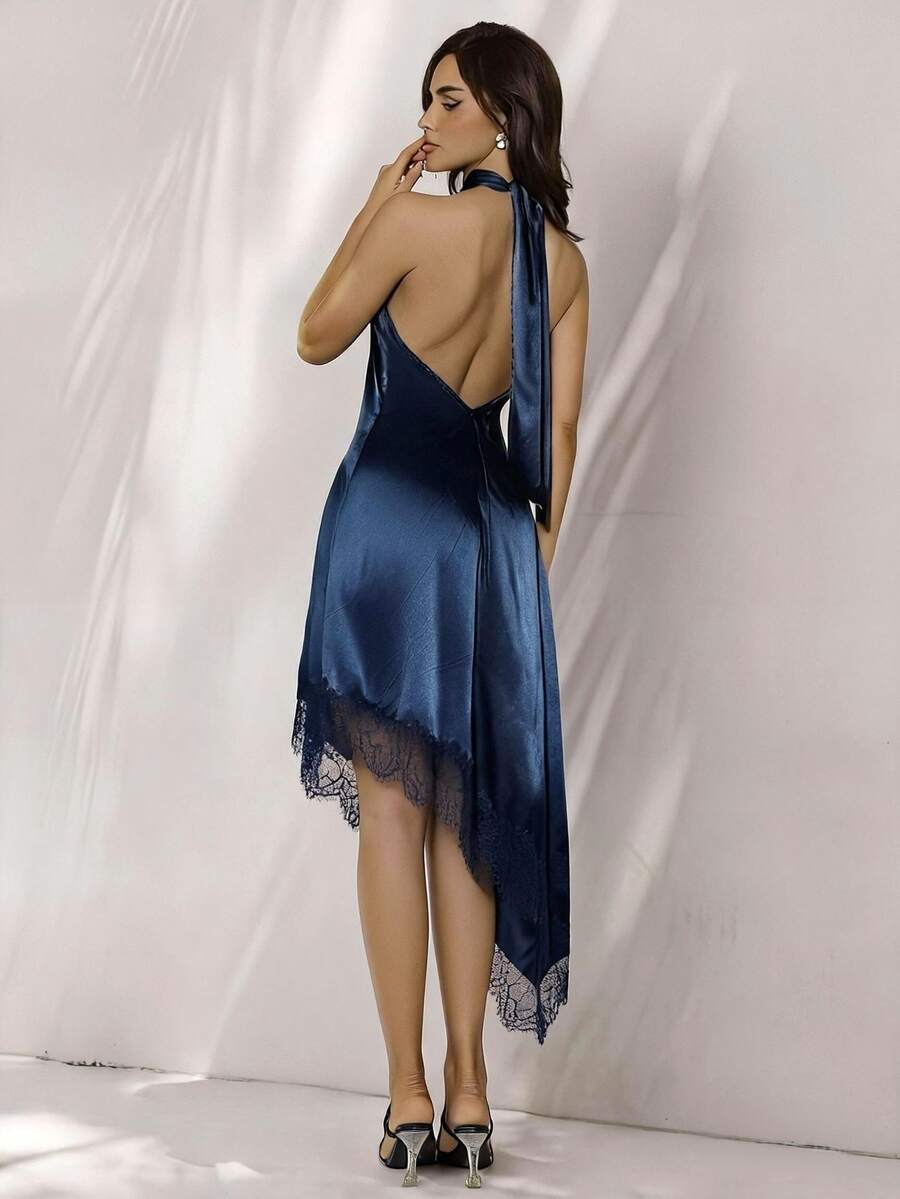 Back view of navy satin halter mini dress with open back and long neck ties
