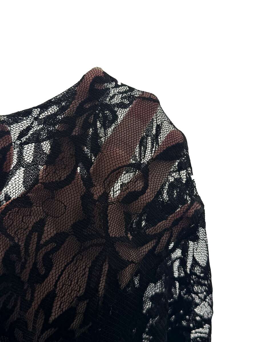 Close-up of black floral lace fabric on gothic dress sleeve