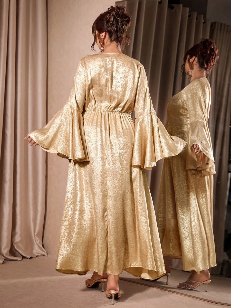 Back view of gold evening gown showing gathered waist and flowing skirt