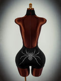 Back view of black backless unitard with rhinestone spider and center zipper