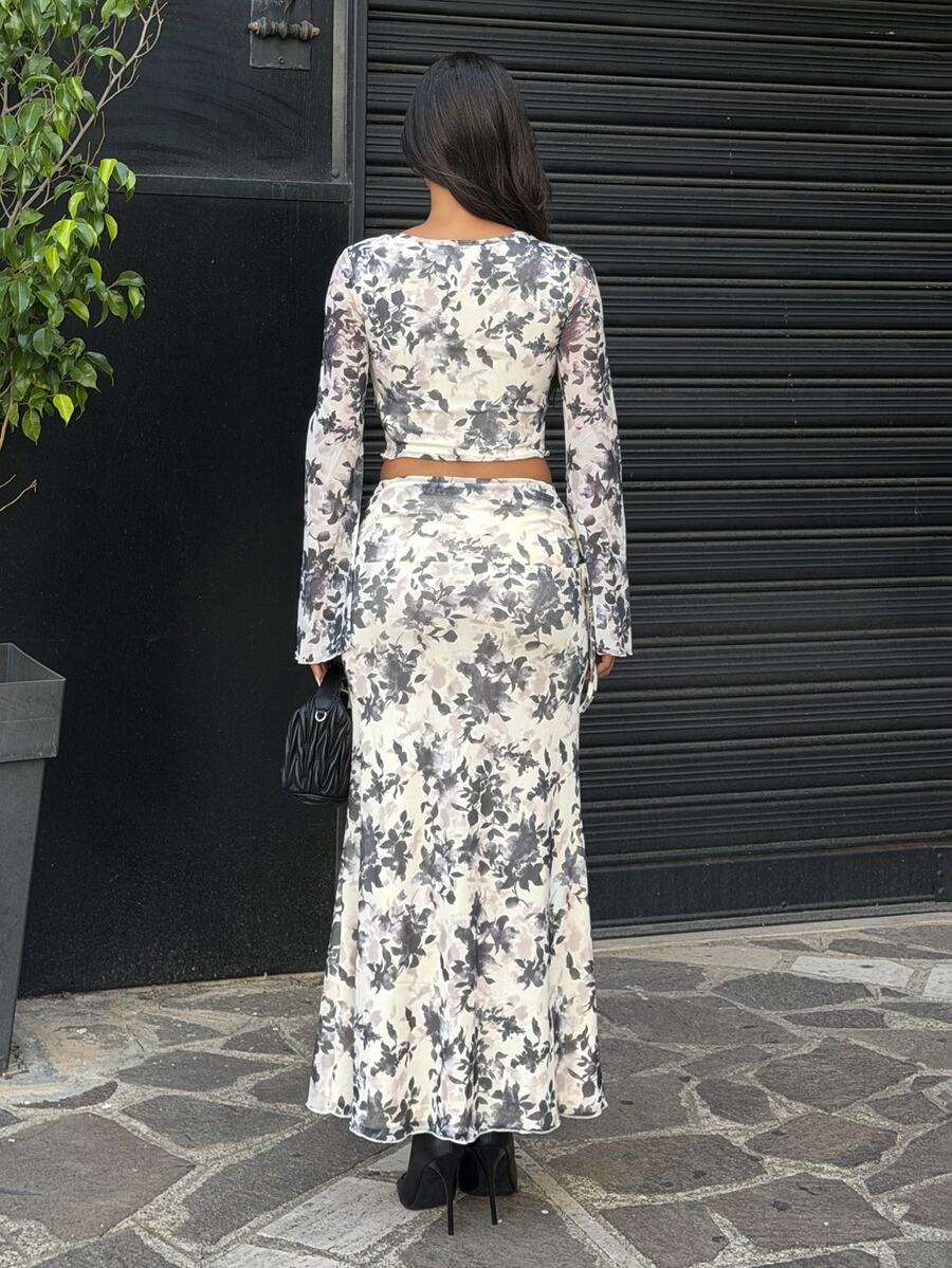 Full front view of ivory and charcoal floral crop top and long skirt set styled outdoors