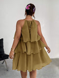 Back view of olive tiered halter dress with tie detail