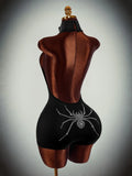 Rear angled view of black short unitard with rhinestone spider graphic