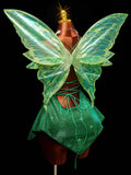 Back view of green sparkly fairy mini dress with translucent butterfly wings