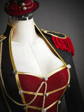 Close view of red glitter bodice panel, gold braid and silver buttons on military dress