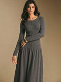 Back view of the charcoal gray maxi dress showing a smooth fitted bodice and flowing gathered maxi skirt