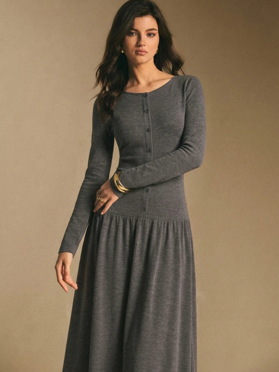 Back view of the charcoal gray maxi dress showing a smooth fitted bodice and flowing gathered maxi skirt