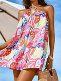Front close-up of red pink tropical floral mini dress styled for vacation