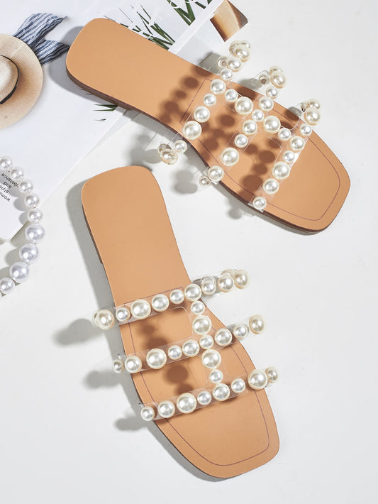These Pearl Perfection slide sandals offer a chic and stylish addition to your summer wardrobe. Made with faux pearls for an elegant touch, these sandals are perfect for adding a touch of luxury to your warm weather attire. Comfortable and fashionable, these sandals are a must-have for any fashion-forward woman.