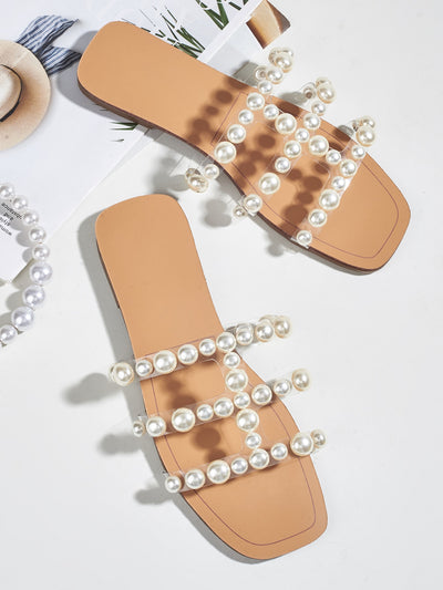 These Pearl Perfection slide sandals offer a chic and stylish addition to your summer wardrobe. Made with faux pearls for an elegant touch, these sandals are perfect for adding a touch of luxury to your warm weather attire. Comfortable and fashionable, these sandals are a must-have for any fashion-forward woman.