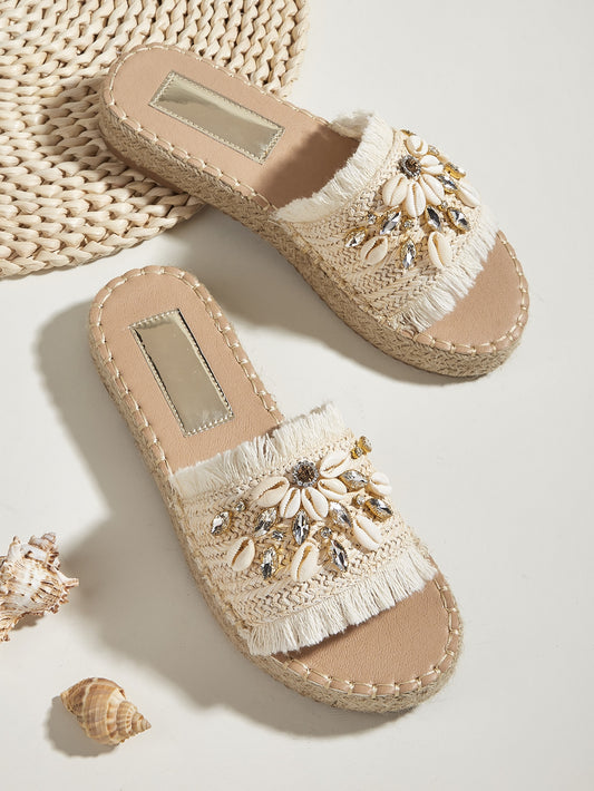 Elevate your vacation style with our Rhinestone Shell Decor Espadrille Sandals. These beige outdoor straw flats feature a unique and stunning rhinestone shell design, truly making them the ultimate vacation footwear. Keep your feet comfortable and fashionable on all your adventures.
