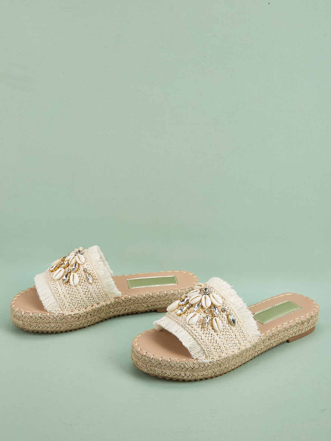 Elevate your vacation style with our Rhinestone Shell Decor Espadrille Sandals. These beige outdoor straw flats feature a unique and stunning rhinestone shell design, truly making them the ultimate vacation footwear. Keep your feet comfortable and fashionable on all your adventures.