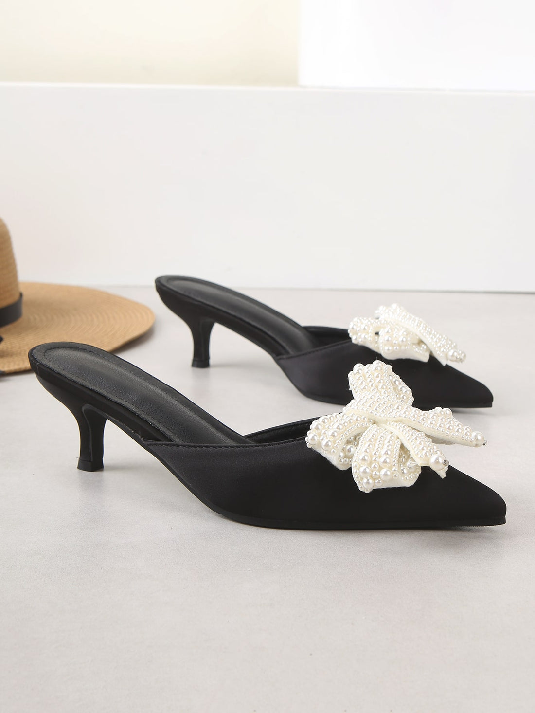 Elevate your style with these chic and feminine mule pumps. Featuring a delicate bow decoration and a flattering point toe, these shoes add a touch of sophistication to any outfit. Step out in style and confidence with these versatile and trendy pumps.