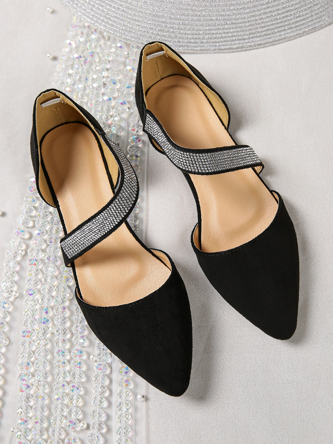 Elevate your style with our Sparkling Rhinestone Strappy Flats. Made with black suedette for a touch of elegance, the contrast color adds a fashionable twist to these <a href="https://canaryhouze.com/collections/women-canvas-shoes" target="_blank" rel="noopener">shoes</a>. With sparkling rhinestones for some subtle glam, these flats are perfect for any occasion.