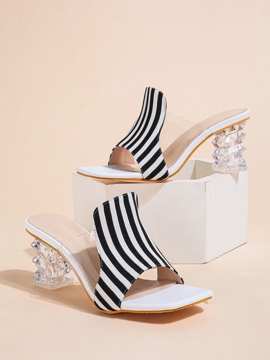 Experience effortless summer style with our Sculptural Chic Heeled Mule Sandals. The striped pattern adds a touch of chic to any outfit, while the comfortable heel offers both style and support. Slip into these sandals for a fashionable and hassle-free summer