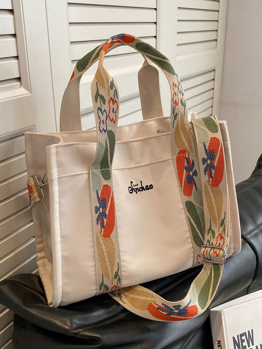 Elevate your everyday style with our Stylish Floral Letter Graphic Shopper <a href="https://canaryhouze.com/collections/canvas-tote-bags" target="_blank" rel="noopener">Tote Bag</a>. Featuring a detachable flower print strap, this bag is both practical and trendy. Carry all your essentials in style while making a statement with our eye-catching floral design. Perfect for a day out or a trip to the shops.