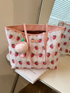 Effortlessly carry all your essentials with the Strawberry Bliss tote bag. The large capacity is perfect for busy women on the go, while the attached bag charm adds a touch of preppy, funny, and cute style. Stay organized and stylish with this must-have tote bag.
