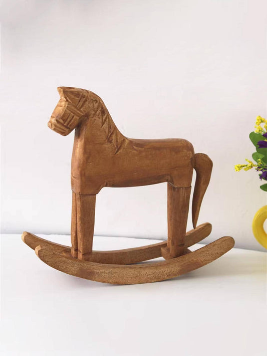 This elegant wooden <a href="https://canaryhouze.com/collections/ornaments" target="_blank" rel="noopener">horse décor</a> is the perfect addition to any stylish home interior. Crafted with precision and attention to detail, this piece exudes sophistication and adds a touch of luxury to any space. Made from high-quality materials, it is not only visually appealing but also durable and long-lasting. Enhance your home's aesthetic with this exquisite decoration.