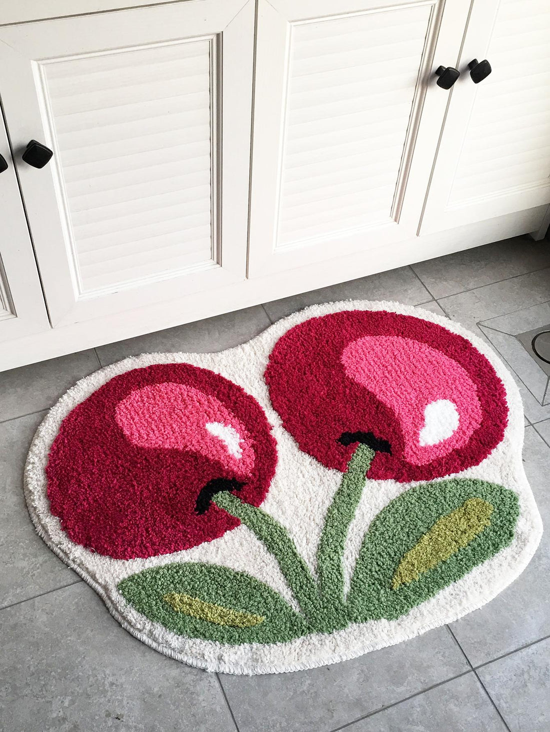 This charming cherry door mat is made with modern polyester fabric that is perfect for indoor and outdoor use. Its non-slip and absorbent design makes it ideal for any household, providing safety and cleanliness. Enjoy its beautiful cherry design while keeping your home tidy.