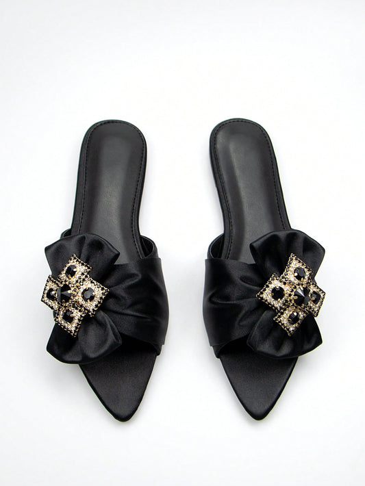 Introducing the Sparkle and Shine: Satin Rhinestone Bow Slide Sandals for Women! These sandals feature a stylish satin construction with a dazzling rhinestone bow. Slip into pure comfort and glamour with these versatile sandals. Perfect for any occasion, add a touch of sparkle to your shoe collection now.