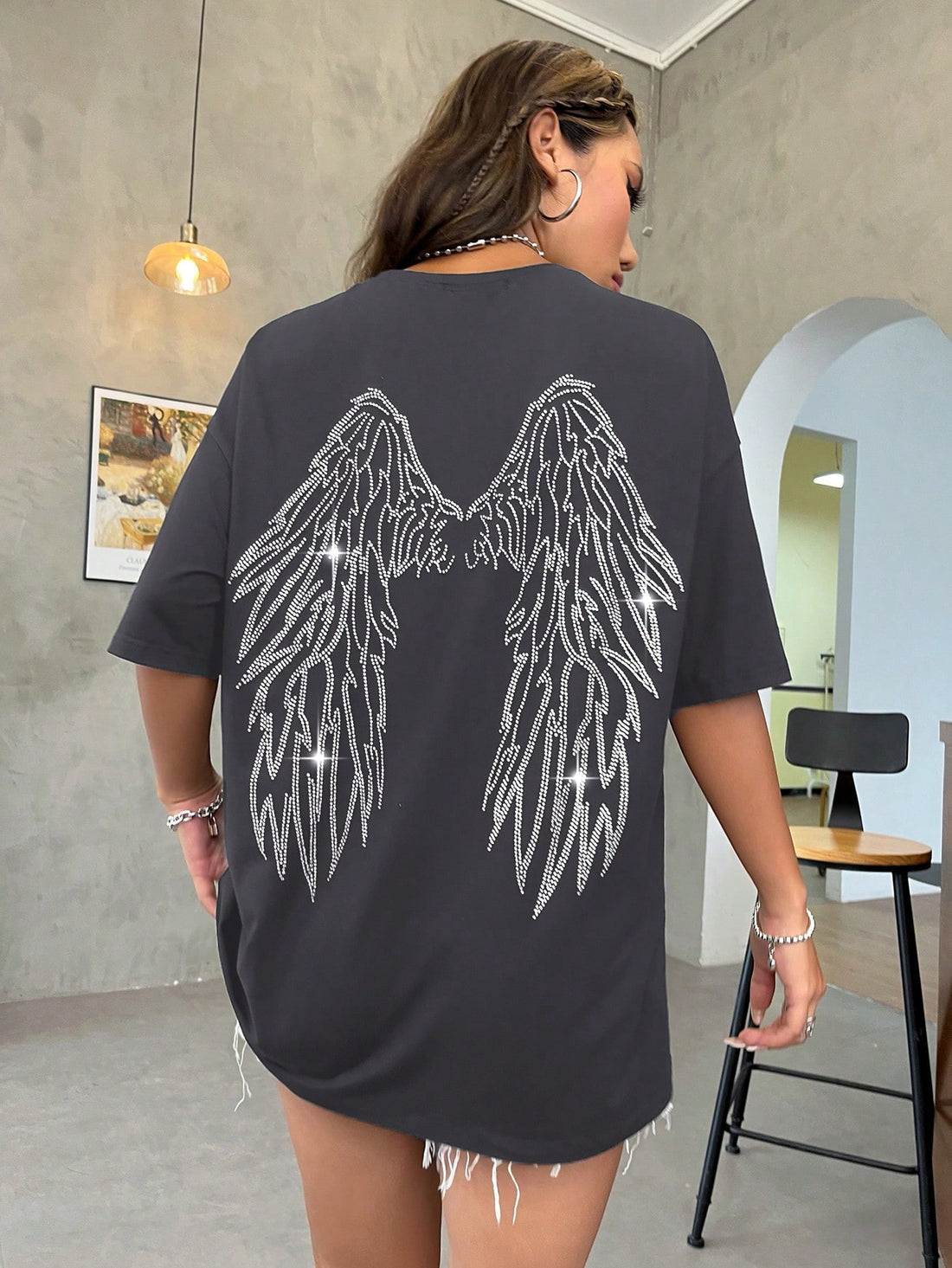 Discover your inner goddess with our Sparkling Wings Drop Shoulder Tee. This versatile and stylish tee features a unique drop shoulder design and sparkling wing detailing, perfect for adding a touch of glamour to any outfit. Embrace your confidence and elevate your style with this must-have piece.