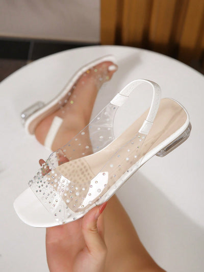 Introducing Sparkling Steps: Rhinestone Decor Clear Strap Slingback <a href="https://canaryhouze.com/collections/women-canvas-shoes" target="_blank" rel="noopener">Sandals</a>. These stunning sandals feature a rhinestone decoration, adding a touch of sparkle to your step. The clear straps and slingback design create a sleek and stylish look, perfect for any event. Elevate your style with these must-have sandals.