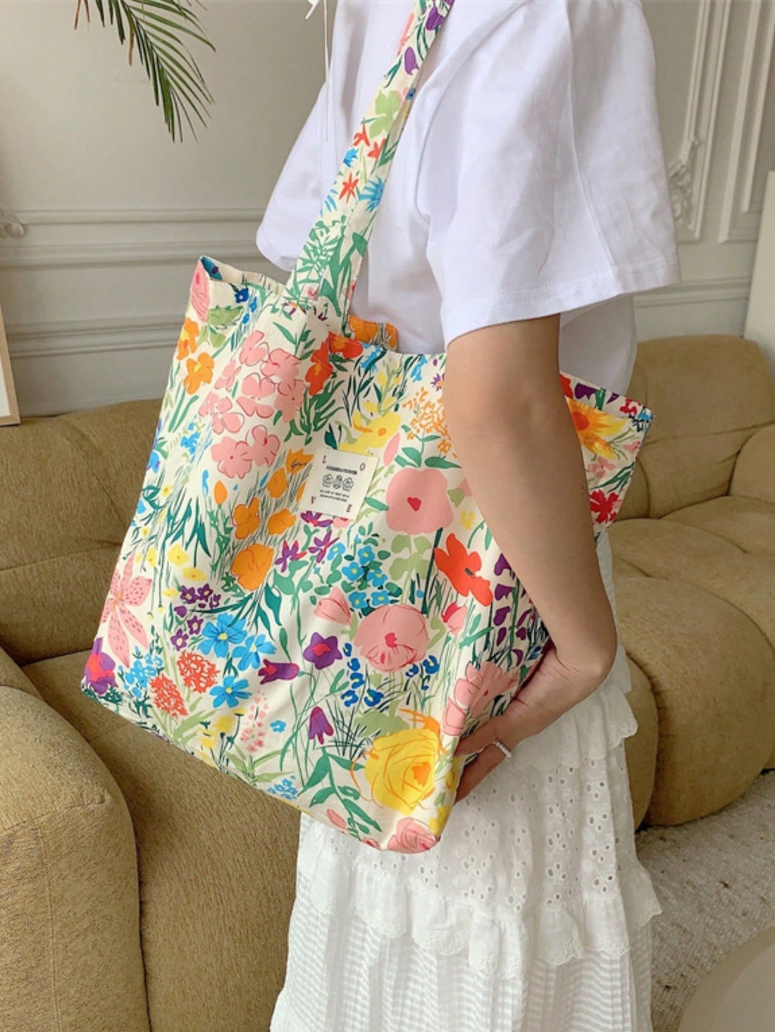 This spacious canvas shoulder <a href="https://canaryhouze.com/collections/canvas-tote-bags" target="_blank" rel="noopener">bag</a> is the perfect companion for a day at the beach or a shopping spree. With its large capacity and charming summer floral design, it effortlessly combines fashion and functionality. Stay organized and stylish with this must-have accessory.