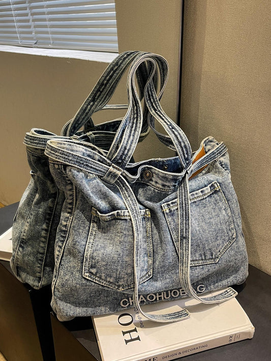 This Chic Denim Large Shoulder <a href="https://canaryhouze.com/collections/canvas-tote-bags" target="_blank" rel="noopener">Tote Bag</a> is the perfect accessory for any fashion-forward individual. Made with high-quality denim and featuring stylish letter embroidery, this bag is both durable and stylish. With dual pockets, it offers convenient storage for all your essentials. Elevate your style with this chic tote bag.